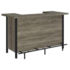 Add functionality and style to an entertainment space with this rustic bar unit, appointed in a gray driftwood-inspired finish with distinctive metal details throughout. Perfect for holding and organizing barware, bottles and all your mixologist essential