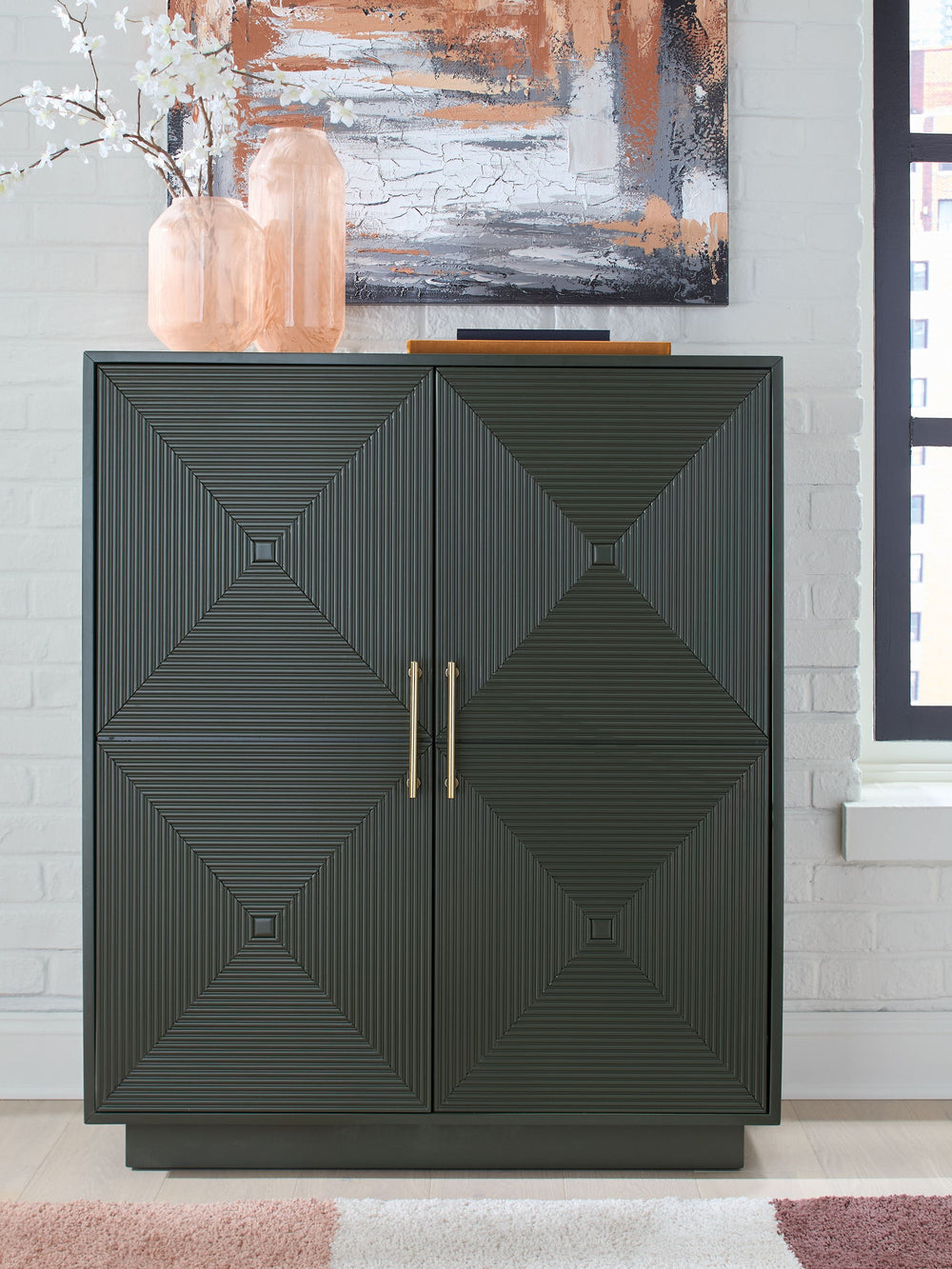 This accent cabinet makes a big impact with just one piece. Its intricately patterned doors impress with their dimension, while the dark green finish and sleek goldtone handles add a touch of modern elegance. Adjustable shelves add everyday functionality 