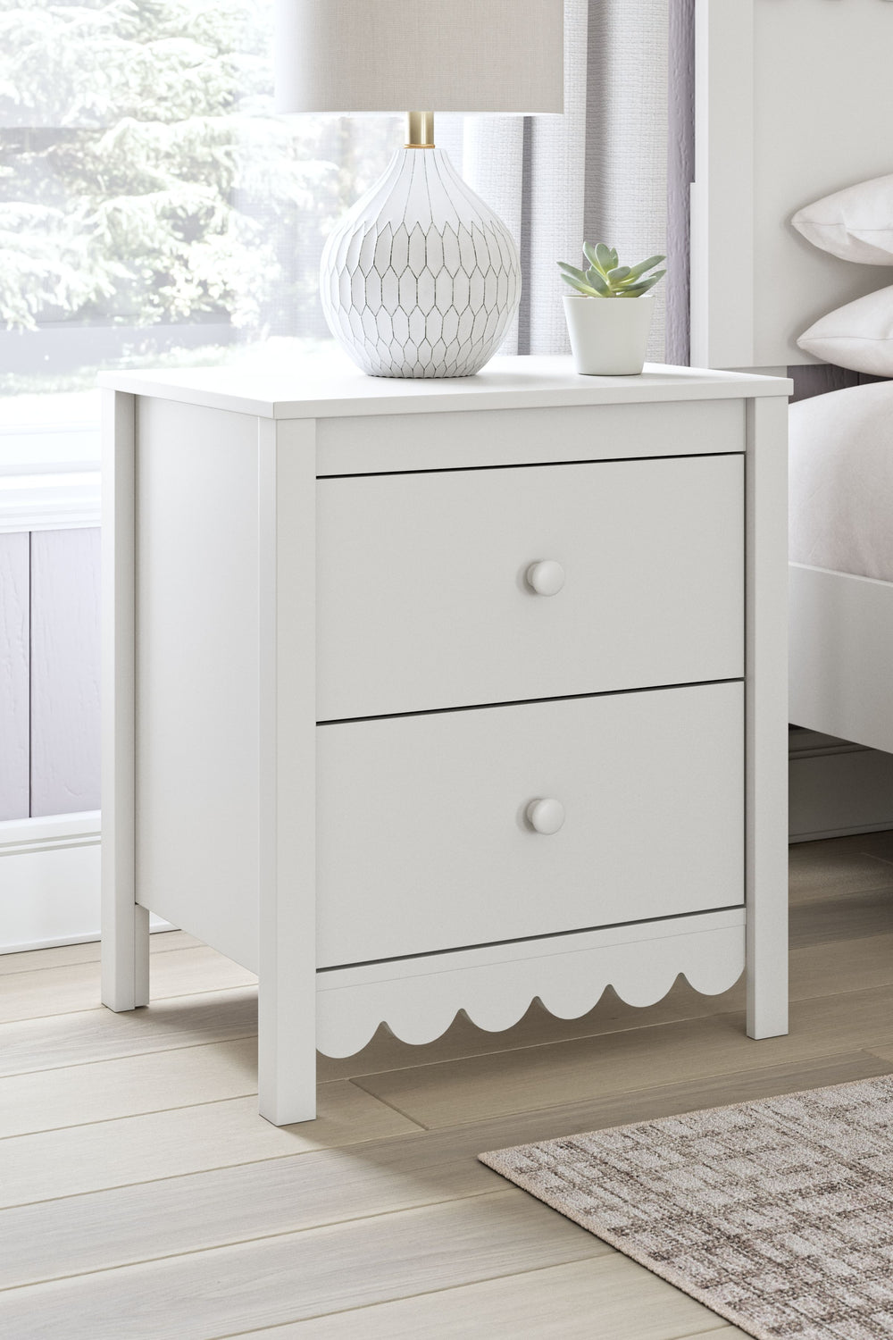 Thanks to its playful scalloped design, this nightstand is the perfect fit for cottage or coastal farmhouse interiors. The matte white finish serves as the perfect backdrop to showcase your personal taste and creativity. And its spacious drawers let you s