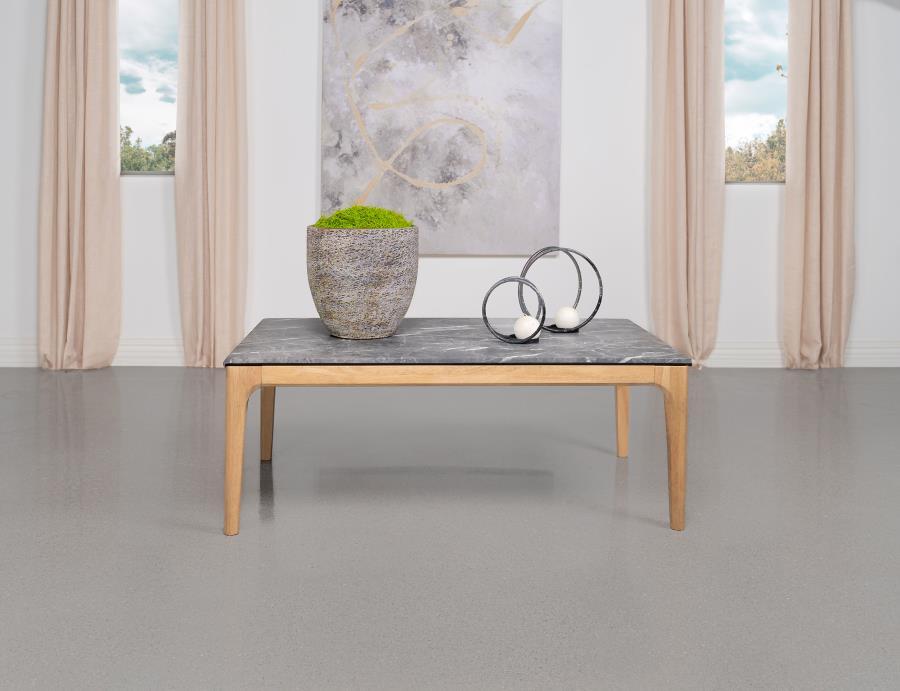 The coffee table stretches out with a confidence born of its mid-century modern heritage, flaunting a rectangular top that offers the luxurious look of marble without the weight. Its high-pressure laminate surface, infused with decorative faux marble lami
