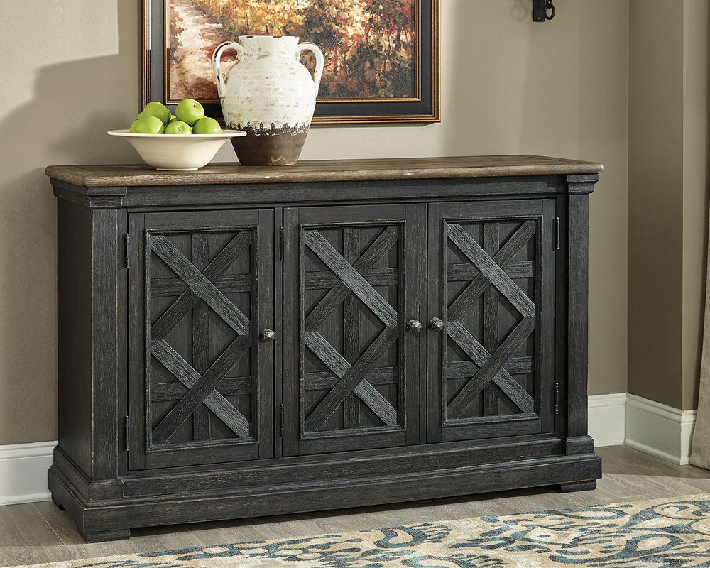 Invite your family into the heart of your home with this dining room server. Its beautifully textured black finish and timeworn planked oak top create a unique two-tone contrast. A charming lattice design graces the front of the doors. Thick pilasters add