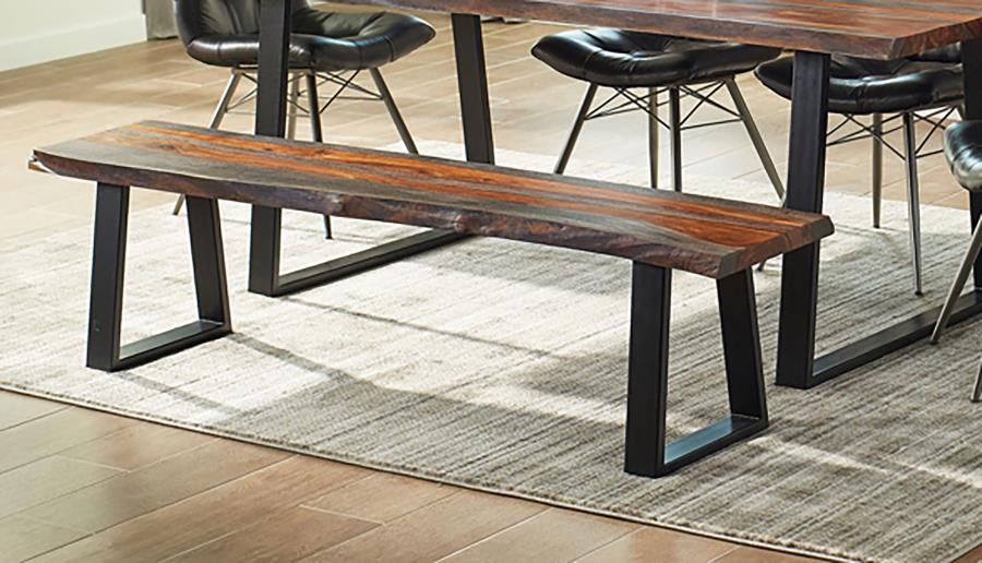 Bring a touch of organic beauty and modern edge to your dining space with this solid sheesham wood dining bench. Featuring a live edge seat, each piece showcases unique natural grain variations for a one-of-a-kind look. The black powder-coated metal base 