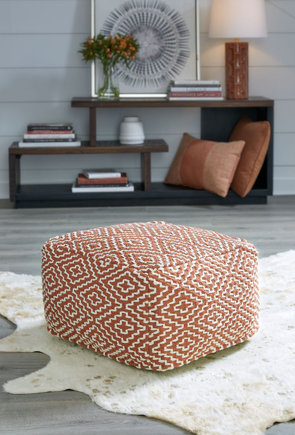 This handwoven pouf is like eye candy for your decor. The perfect perch for kicking up your feet at the end of a long day, it can also be topped with a tray for an instant end table. Youâ€™ll love how beautifully the pouf-'s on-trend geometric design blen