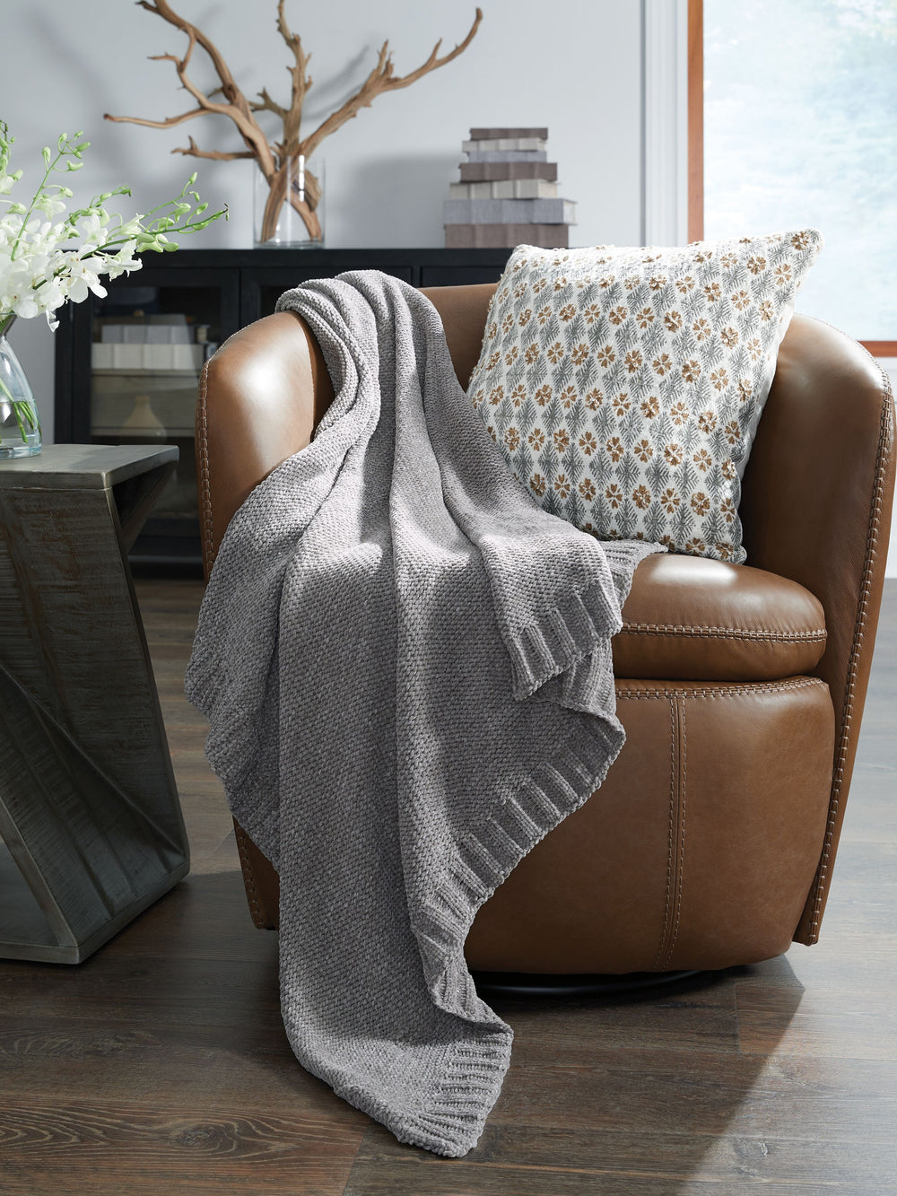 Comfort meets casually chic style in this throw blanket. Its neutral hue and knitted construction create trendy textural variation when draped over a sofa or the foot of a bed. And it goes beyond style, with the soft chenille fabric acting as a cozy compa