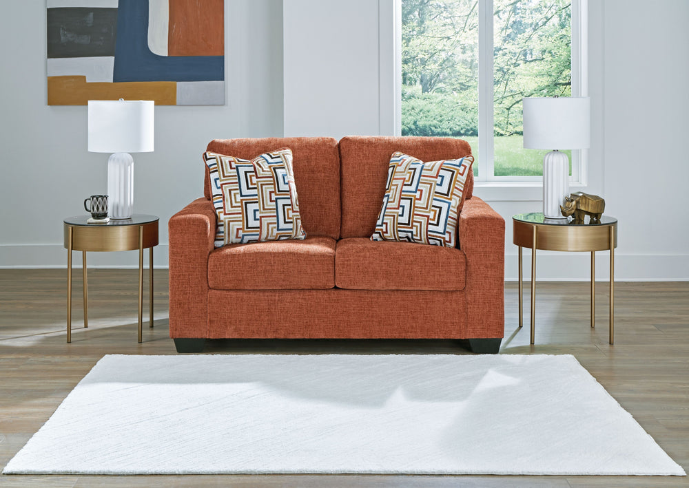 Looking to make a bold statement with color? Liven up your living room with this loveseat. Its trend-right burnt orange upholstery adds a playful pop of color to your decor. Bold and eclectic accent pillows complete the look. Pairing posh style with every