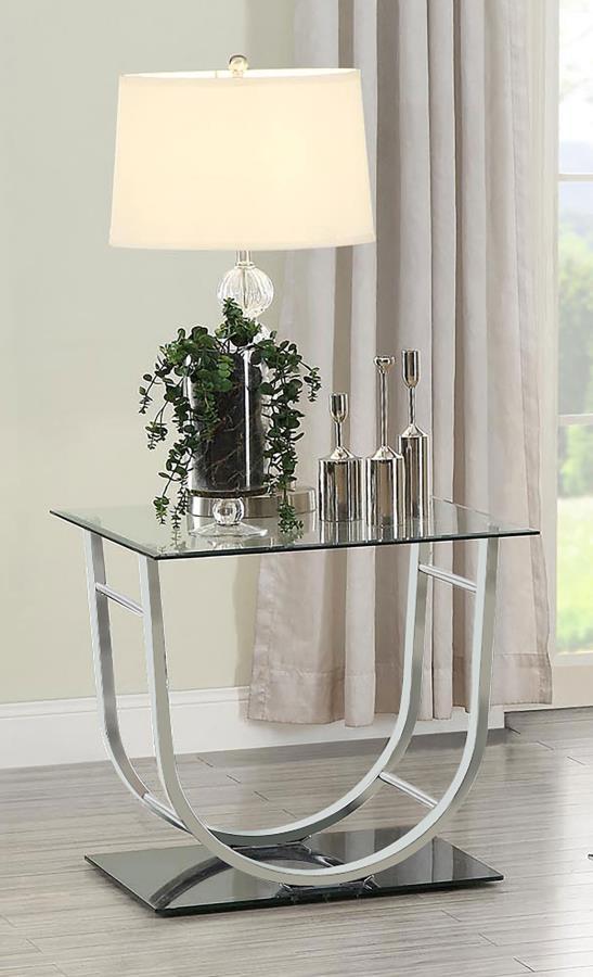 This modern square end table combines a clear tempered glass top with a sleek mirrored base, creating a visually striking design. The curved electroplated heavy gauge metal frame in a polished chrome finish adds elegance and stability. Crafted for durabil