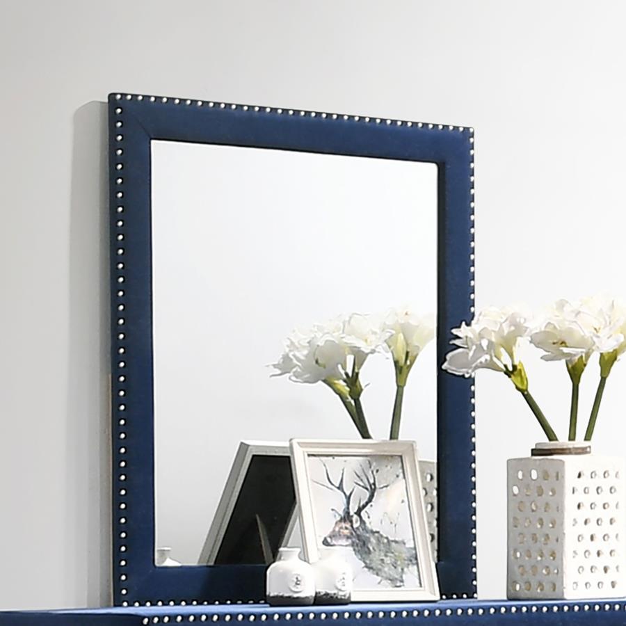 This gorgeous mirror is a masterpiece made for royalty, ready to perk up your sleeping space. Its admirable frame is upholstered entirely in gorgeous velvet fabric. Nail head trim surrounds the frame for a sleek and exquisite upgrade. Place this mirror on
