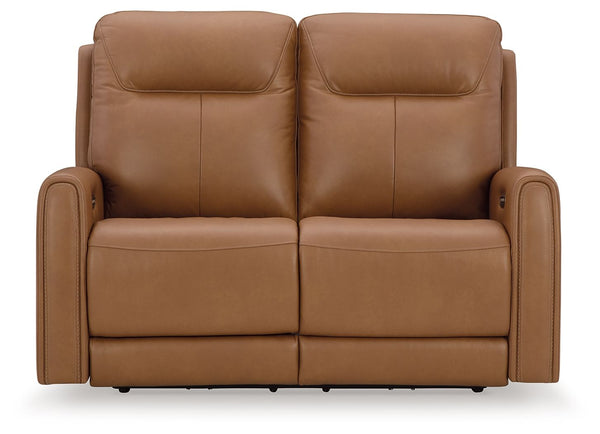 Reserved for him and made for her. This power reclining loveseat delivers all the comfort and style you could ask for. Inspired by sports car interiors, the expertly matched leather and faux leather upholstery features jumbo stitching for even more appeal