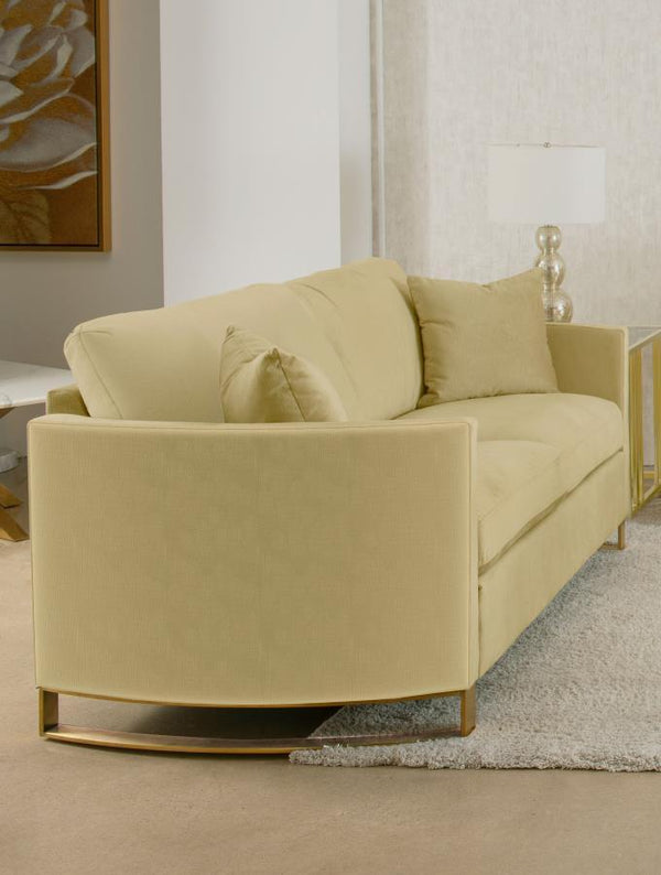  complemented by curved arms and gold stainless steel legs. Smooth upholstery and lustrous details blend simplicity with timeless splendor