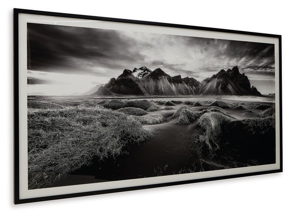  the framed black and white print showcases majestic mountains and a meandering stream. This moody and marvelous piece adds an air of dramatic b