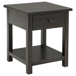 This rustic end table merges classic style with practical storage, making it a charming focal point in any living room. Built from pine wood and reinforced with engineered wood, its square silhouette highlights a subtle, timeworn aesthetic. An integrated 