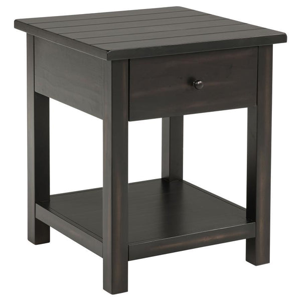 This rustic end table merges classic style with practical storage, making it a charming focal point in any living room. Built from pine wood and reinforced with engineered wood, its square silhouette highlights a subtle, timeworn aesthetic. An integrated 