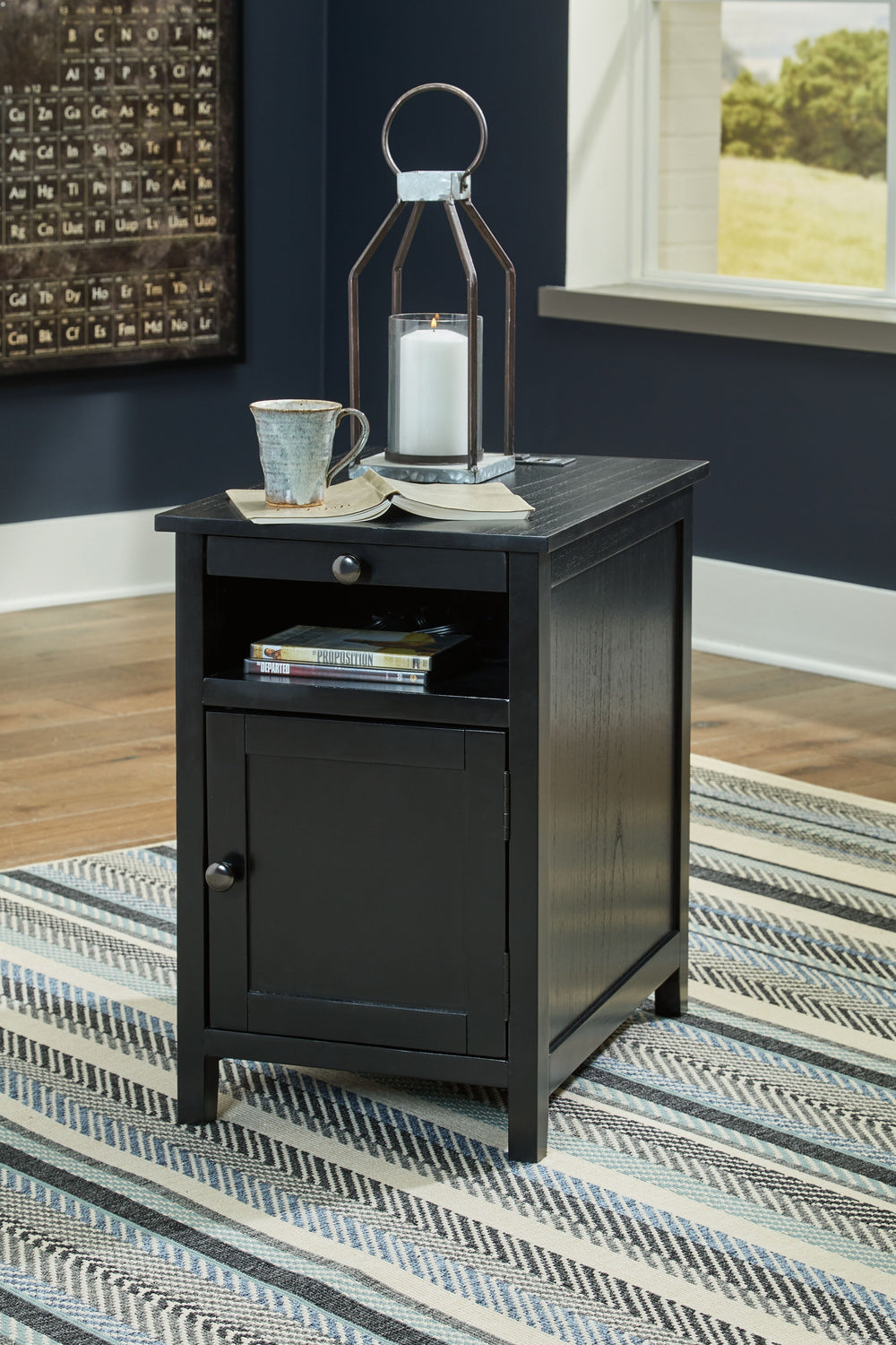 Add big character to a small space with this chairside end table. With its compact size and strong silhouette, it can go anywhere and blend easily into the decor. Less is so much more with the Shaker-inspired design and black wood tone finish. Loaded with