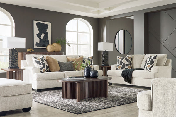 Embrace effortless elegance with this sofa and loveseat set with matching oversized chair and ottoman. Its clean lines and curved details are right at home in contemporary settings. Stressed about styling? The neutral hue easily pairs with your existing c