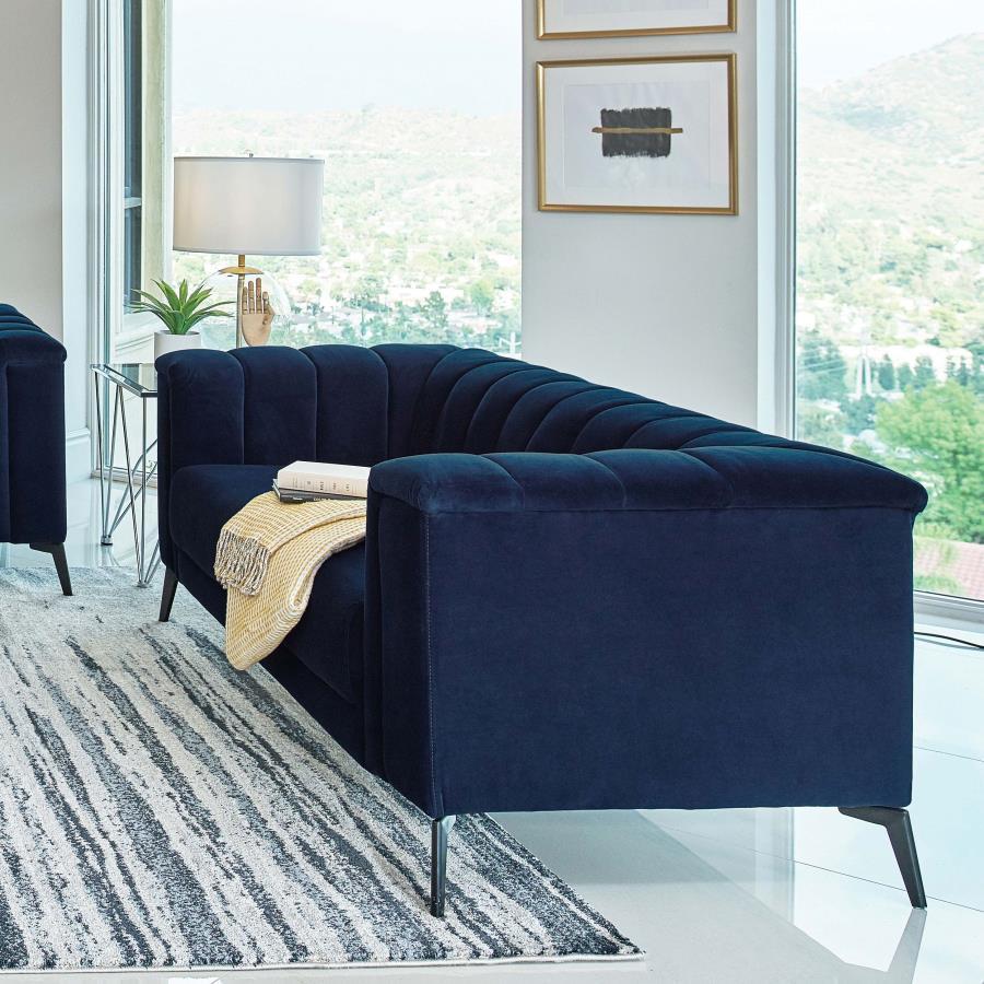 This elegant transitional loveseat will bring a palpable radiance to your home. It-'s upholstered in a vibrant navy blue matte velvet fabric that-'s so soft and stunning that you-'ll have to experience it to believe it. Whether you recline or sit, the ben