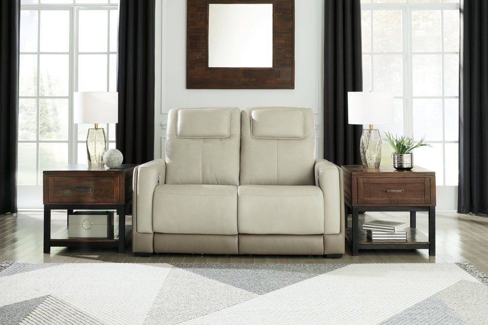 Double down on sleek style with this power reclining loveseat. It has a streamlined, space-conscious appeal, with two-tone upholstery in neutral hues creating subtly striking visual intrigue. And with one-touch reclining, adjustable headrests and wireless