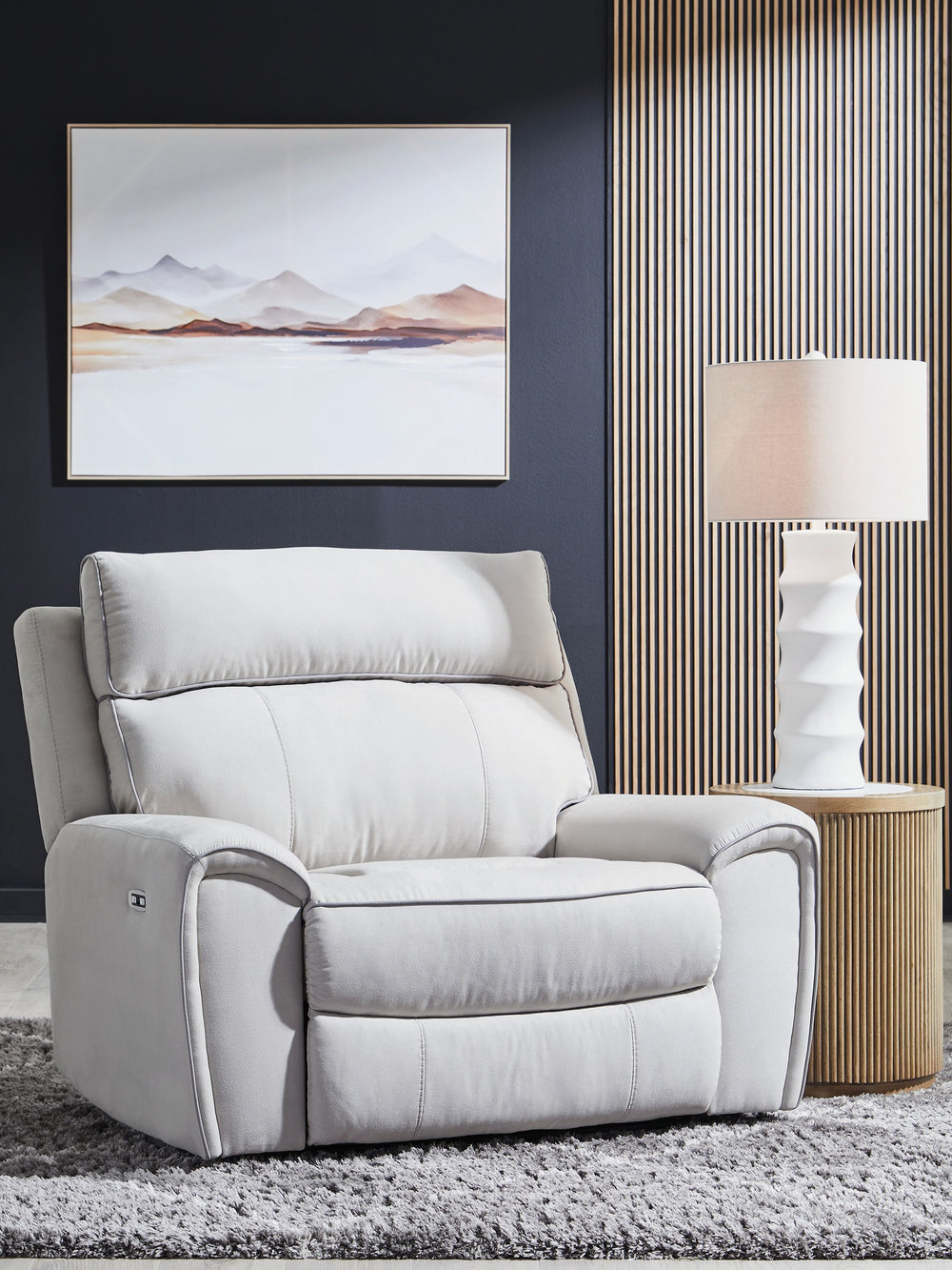 Smart, clean and ultra modern, this power recliner is utterly in vogue. You-'ll love its indulgent cushions and contemporary bustle back styling. The sumptuous fabric, accentuated with contrasting welting, easily blends with your decor. And with reclining