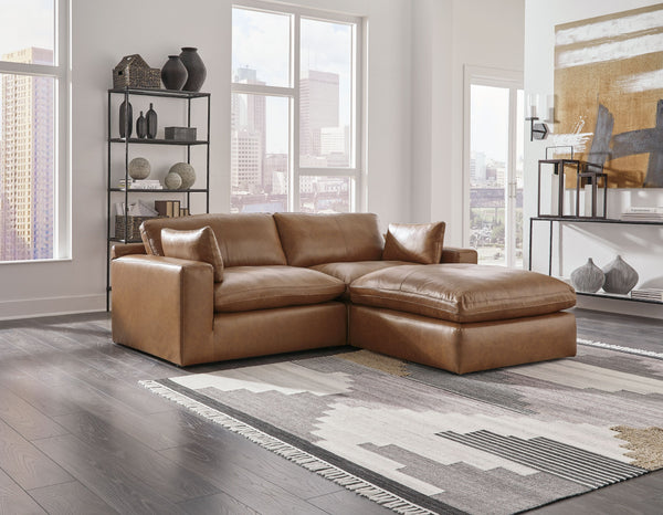 Catering to your contemporary lifestyle, this sectional loveseat and ottoman are a handsome marriage of masculine and feminine sensibilities. Feather-fiber cushions and bolster pillows soften the look of its chunky, linear silhouette. Warmly hued leather 