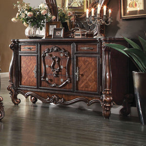 The Versailles dresser is the perfect accent to create the style of royalty your bedroom has been needing. This dresser crafted in wood with cherry oak finish was inspired by old European design with brown copper metal hardware and intricate wood carvings
