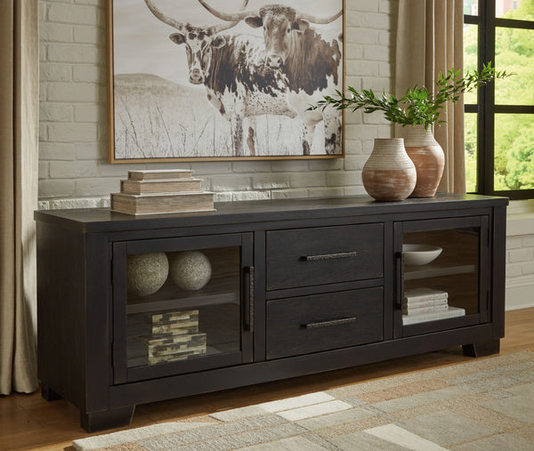  with the worn black finish giving your living room a gently aged charm. Console and media storage is made easy with cabinets and drawers. And the 
