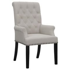 Designed for both luxury and support, this arm chair brings an elegant presence to any dining space. Its button-tufted high back and rolled top lend a timeless aesthetic, while the addition of padded armrests enhances comfort. Hand-applied nailhead trim o