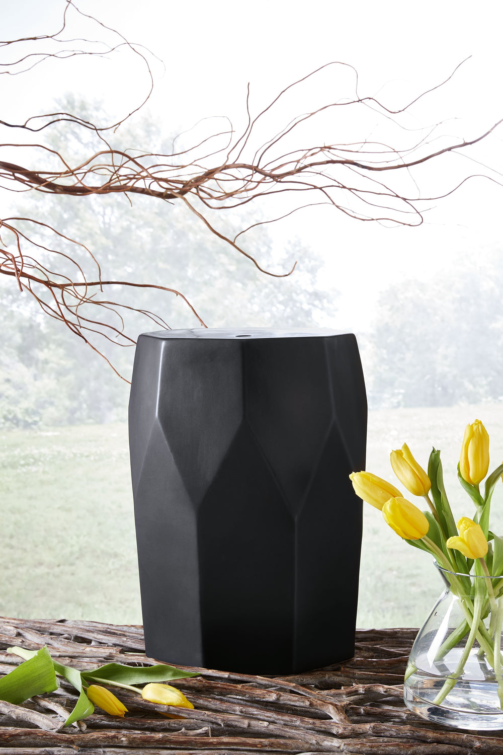 Bring fresh flair to an indoor or outdoor space with this contemporary accent stool. Next to a chair, it-'s the perfect place to set down a drink. And what a pretty perch for a draping plant. However you use it, you-'re sure to appreciate its bold faceted