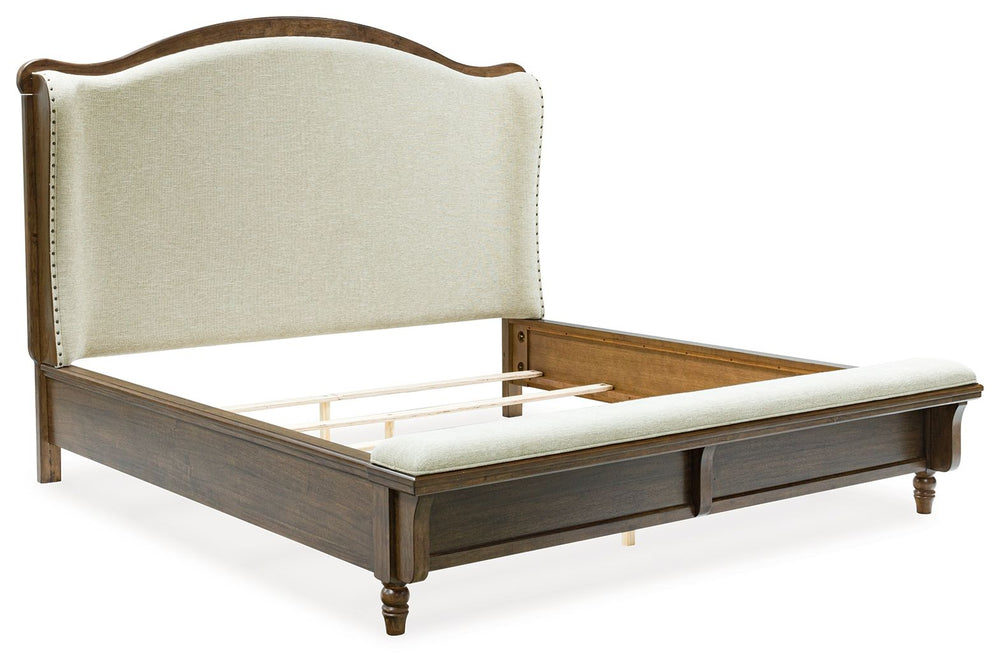 Traditional style doesnâ€™t have to be stuffy. It can feel warm, inviting and beautifully in the moment. Case in point: this California king upholstered panel bed. The alluring piece features a distinctive headboard with a shelter wing design. Its cushion