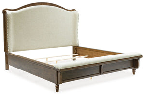 Traditional style doesnâ€™t have to be stuffy. It can feel warm, inviting and beautifully in the moment. Case in point: this California king upholstered panel bed. The alluring piece features a distinctive headboard with a shelter wing design. Its cushion