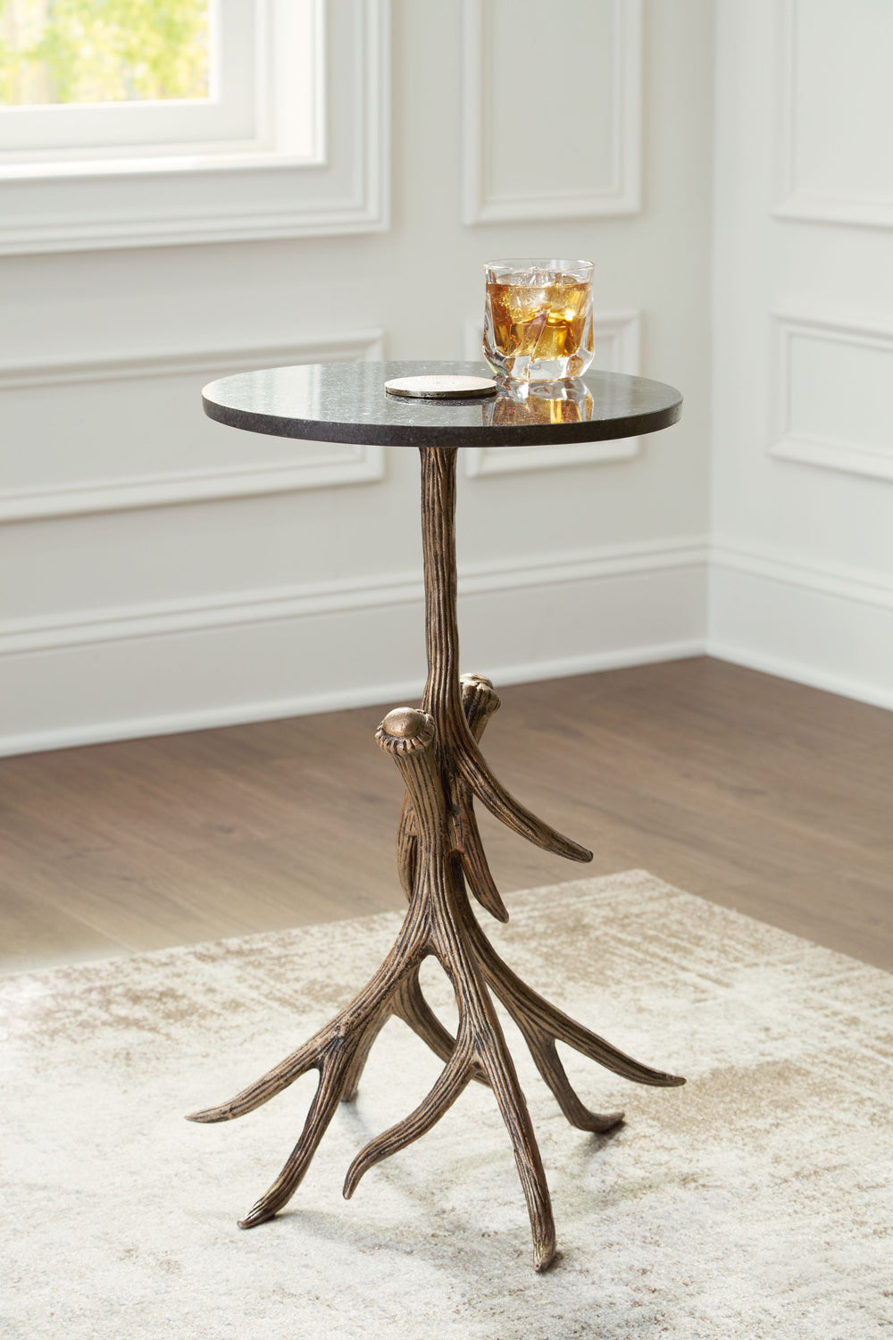 Elevate your living space with the captivating presence of this accent table. Rustic meets contemporary in the nature-inspired statement piece, which effortlessly delivers unique character. Faux antlers and a black marble top add a touch of elegance and c