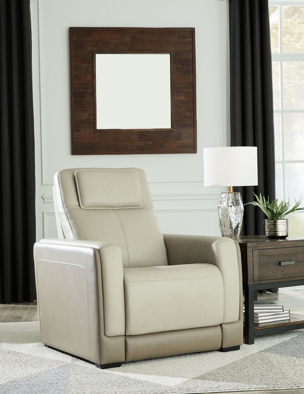 Double down on sleek style with this power recliner. It has a streamlined, space-conscious appeal, with two-tone upholstery in neutral hues creating subtly striking visual intrigue. And with one-touch reclining, an adjustable headrest and wireless chargin