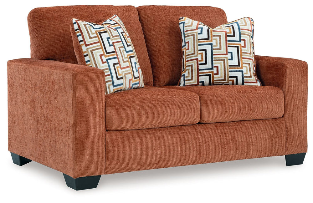 Looking to make a bold statement with color? Liven up your living room with this loveseat. Its trend-right burnt orange upholstery adds a playful pop of color to your decor. Bold and eclectic accent pillows complete the look. Pairing posh style with every