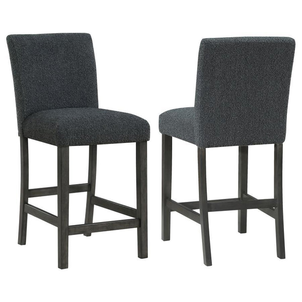 Elevate your dining experience with this chic counter height chair, a blend of simplicity and texture. Wrapped in the luxurious touch of boucle fabric, the chair offers a tactile feast, inviting guests to savor every second seated. Its silhouette stands t