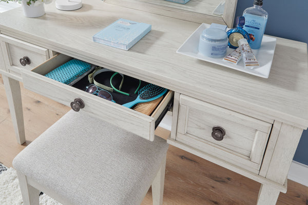  timeless furnishings take your bedroom to the next level. Nothing does that better than this vanity and stool set. The antiqued white finish with a wonderful grain texture radiates sophistication