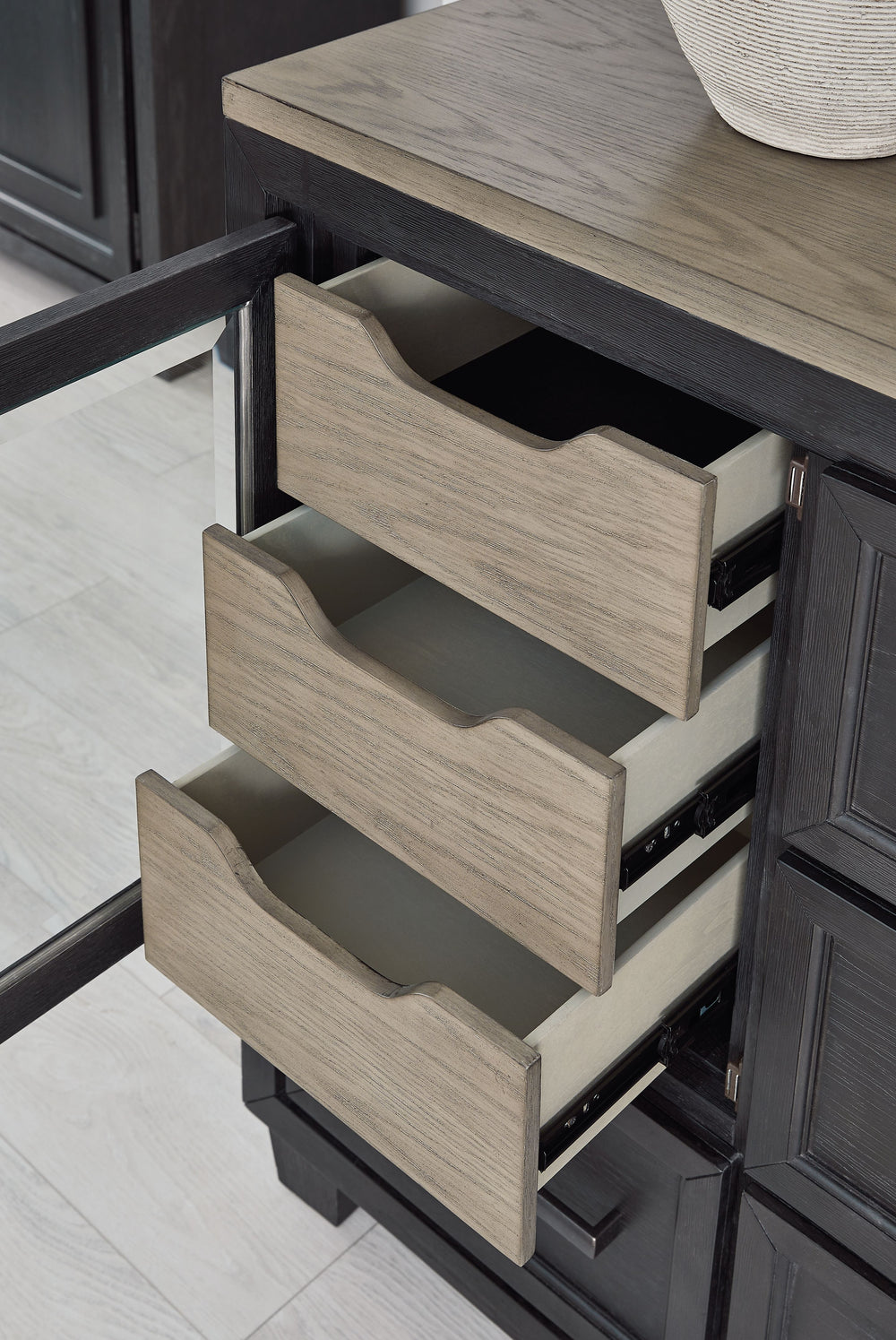 This dresser and mirror set is casual contemporary style simply done right. Its two-tone color scheme features a rich brushed black main color accented with a beautiful dusty grayish brown wood tone. With 11 soft-close drawers (three located neatly behind