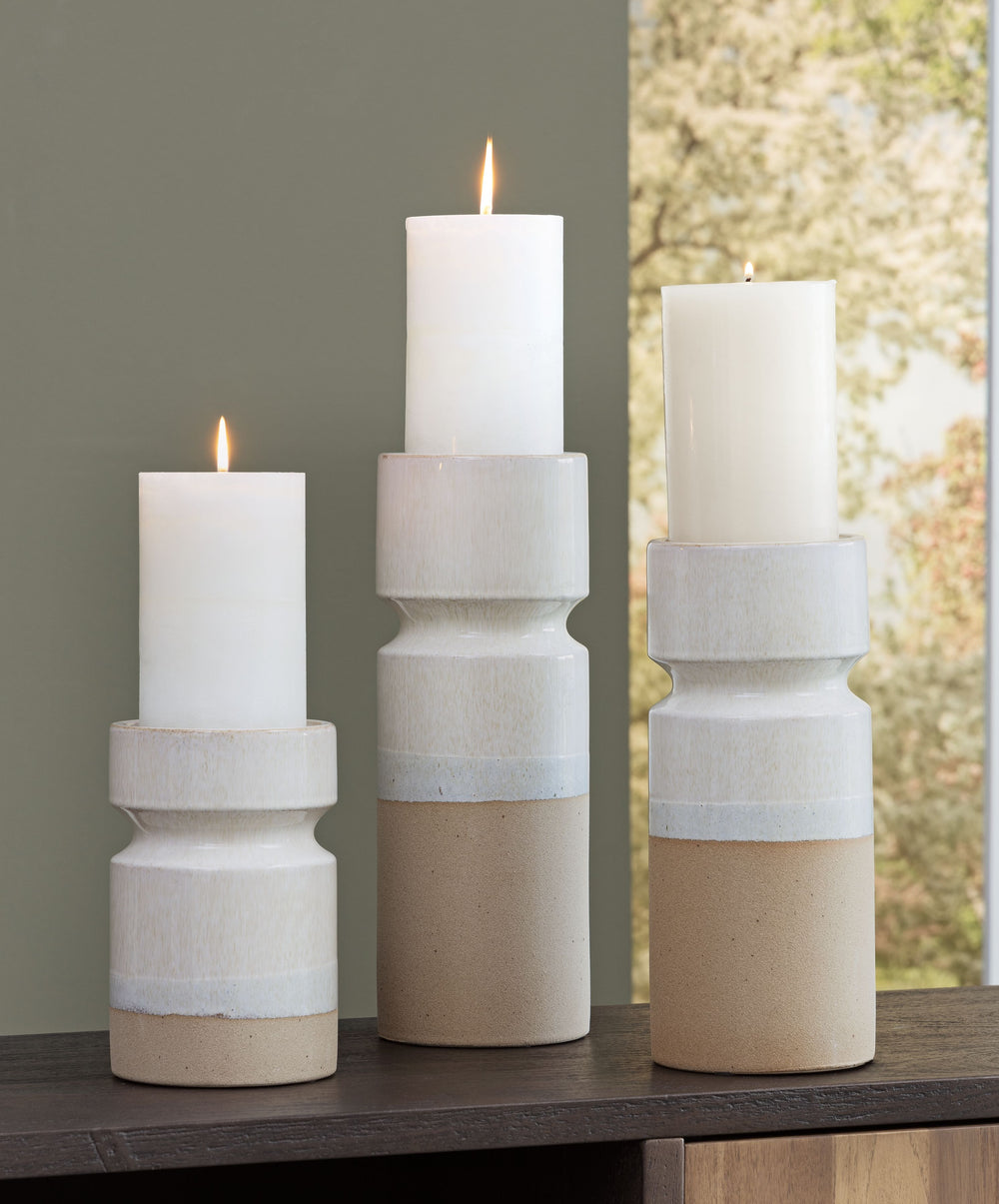 Exuding a sense of earthy elegance, this candle holder set is one tantalizing trio. With their varying heights, these candle holders permeate just the right ambiance when displayed individually or in a group. They-'re finished with a reactive glazeâ€”a te