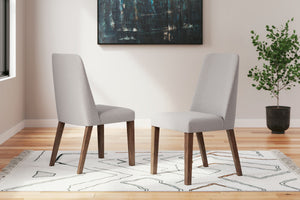 A refreshed take on retro aesthetics. This side chair adds an air of playful simplicity to your dining space, capturing the architectural language of mid-century stylings. The seat invites the eye with a soft-edged silhouette and light gray cushion. A cas