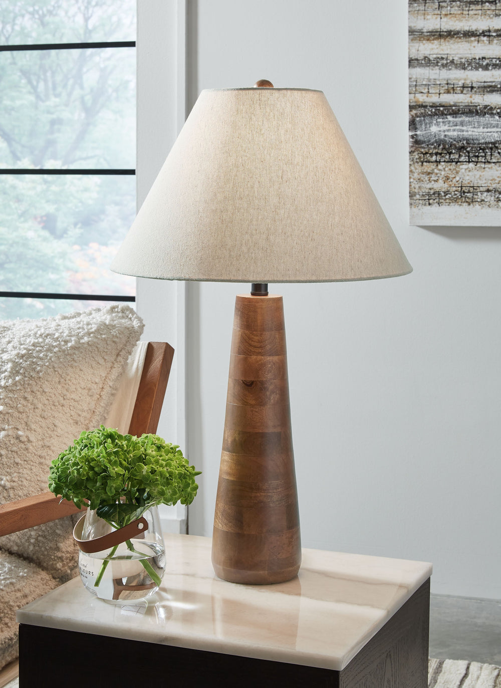 Clean, contemporary style can be sleek and shinyâ€”or subtle and earthy. We love how this table lamp falls into the latter category. Pairing a stylish shade with a wood base bathed in a honey brown finish, it has a delightfully different yet simply illumi