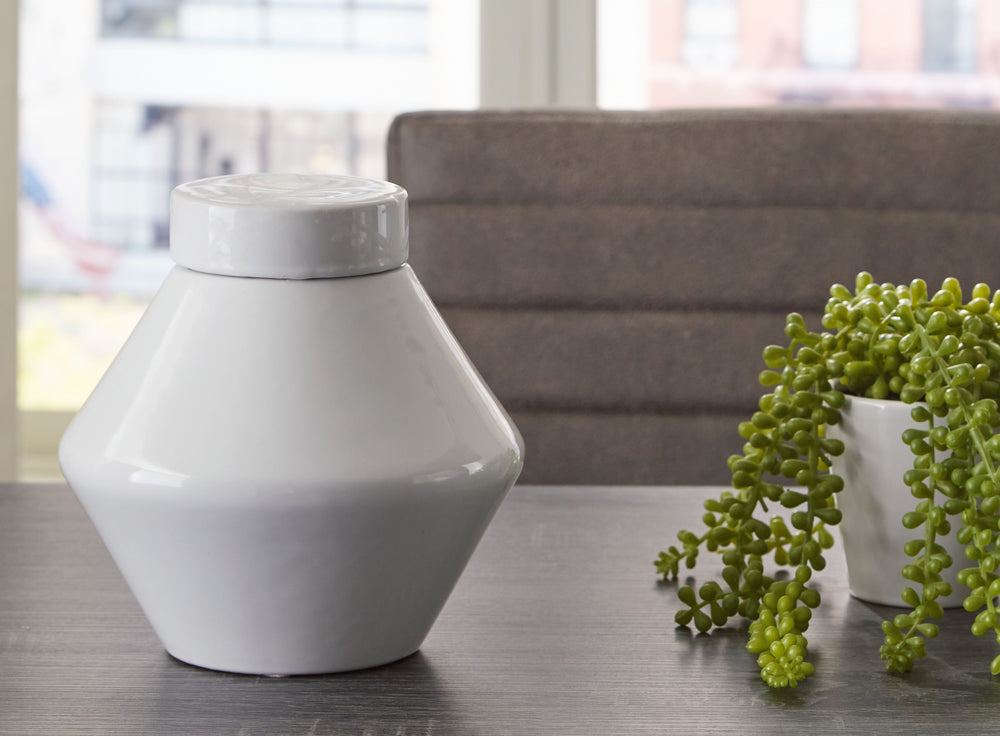 Show off your sense of curated good taste with this glazed ceramic jar with removable lid. Minimalistic and modern, it-'s the embodiment of sleek style.<br/><br/><b>Product Features</b><ul><li>Made of ceramic</li><li>White glazed finish</li><li>Removable 