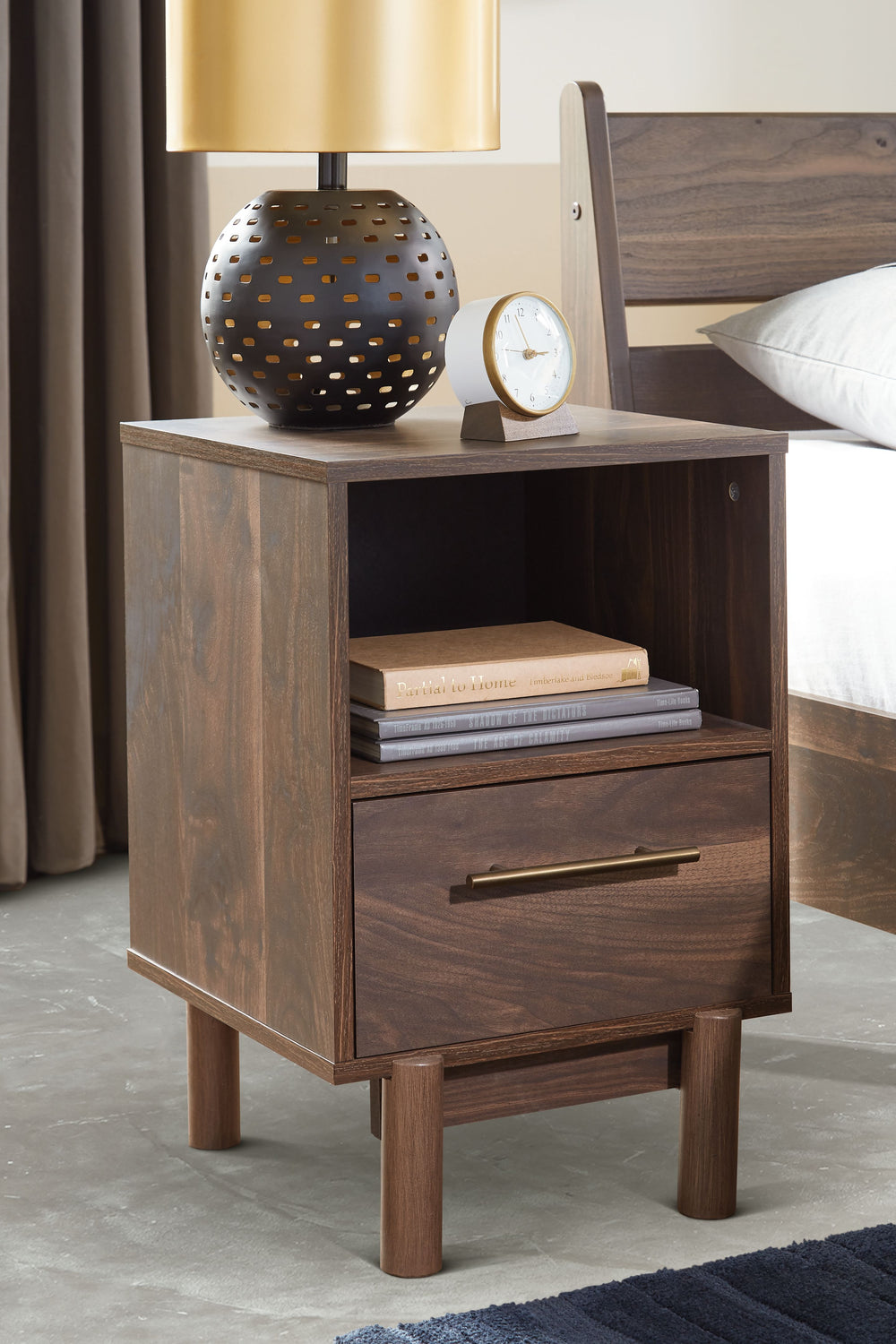 At the intersection of industrial cool and chic sophistication youâ€™ll find this nightstand. With a rich brown finish over replicated walnut wood grain, paired with a burnished goldtone handle, it offers an authentic touch that plays well any way you sty