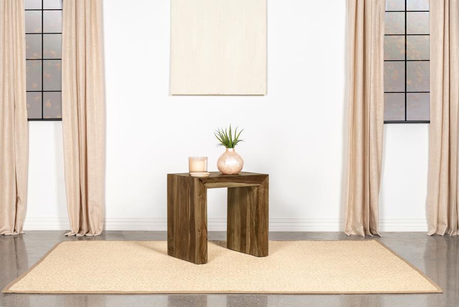 This rectangular end table pairs modern simplicity with rustic charm, featuring a robust U-shaped silhouette and clean lines. Crafted from sustainable solid sheesham wood, its layered auburn finish highlights the natural grain patterns, adding depth and c