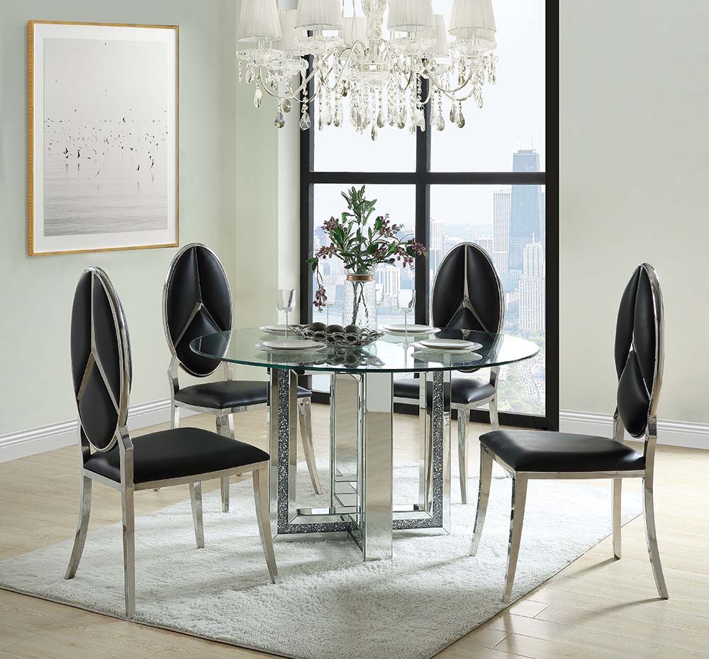 Create a sophisticated modern dining room with the Ningbo round mirrored base dining table. The sleek tempered glass tabletop delivers a stunning complement to the glamorous mirrored geometric base that is accentuated with inlaid crystals. Place by a wind