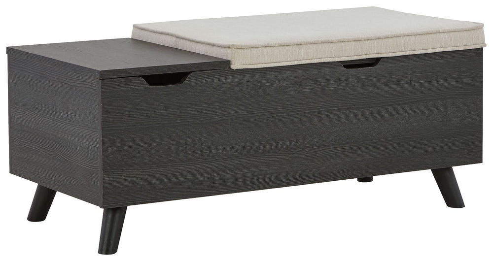The clean profile of this small storage bench makes an entrance anywhere and everywhere you place it. Replicated blackened wood finish with a grayed textural grain and tapered wood legs lend a fresh flair. Adding form and function, both tops are removable