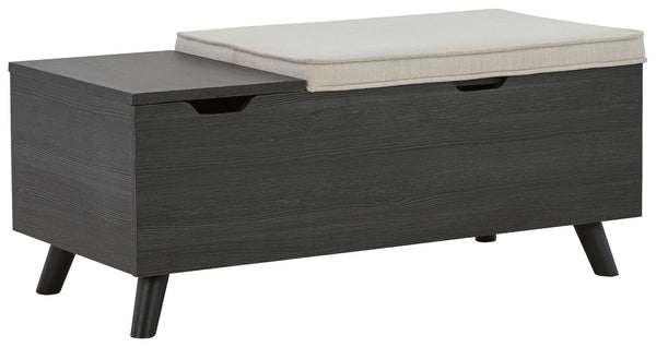 The clean profile of this small storage bench makes an entrance anywhere and everywhere you place it. Replicated blackened wood finish with a grayed textural grain and tapered wood legs lend a fresh flair. Adding form and function, both tops are removable