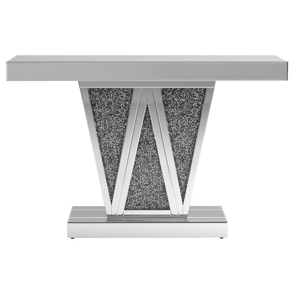 Make a bold statement with this contemporary glam console table, designed to impress with its striking silhouette and luxe materials. The silver mirrored finish is paired with a geometric W-shaped base, inlaid with shimmering faux crystal accents for a da