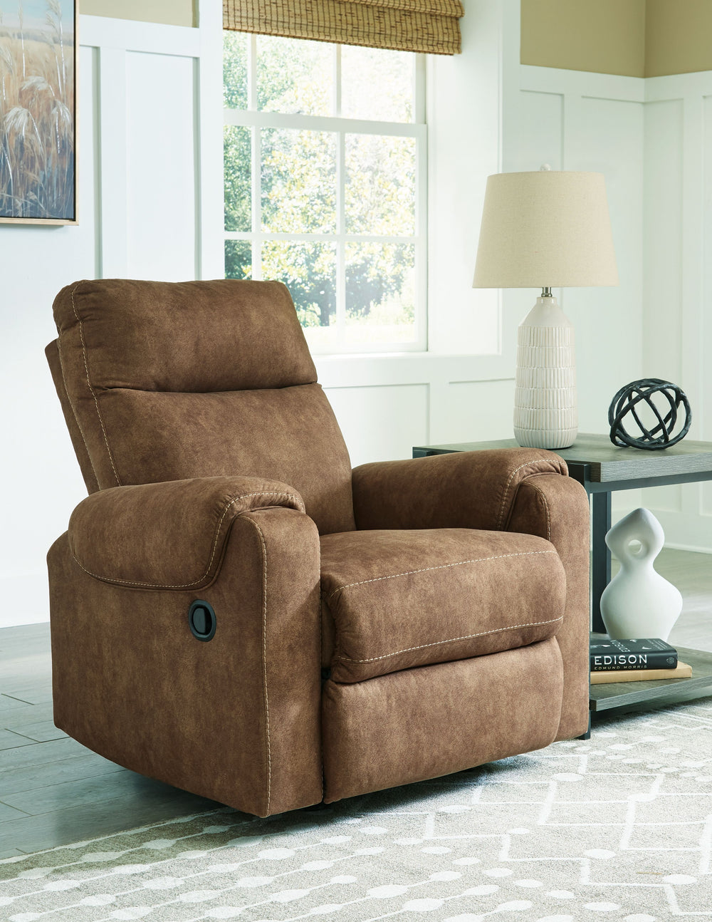 This rocker recliner is your best shot for comfort and total relaxation. Its super soft faux leather, contemporary bustle back and contrast stitching team up for a big win with most any color scheme and room decor. With the pull tab reclining motion, you 