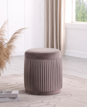  offering flexibility to serve as footrest or seat. It features mauve upholstery with a deep