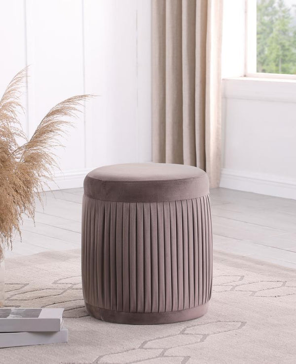  offering flexibility to serve as footrest or seat. It features mauve upholstery with a deep