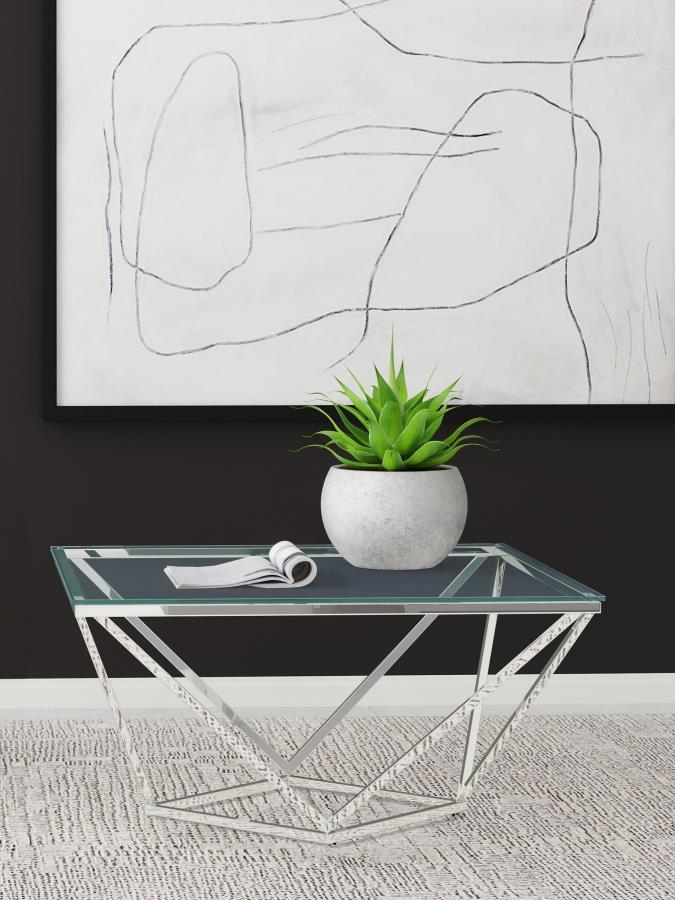 This modern end table showcases a bold geometric base in a polished nickel finish, paired with a durable clear tempered glass top. The tempered glass surface offers scratch resistance and effortless upkeep, while the nickel-finished steel frame ensures la
