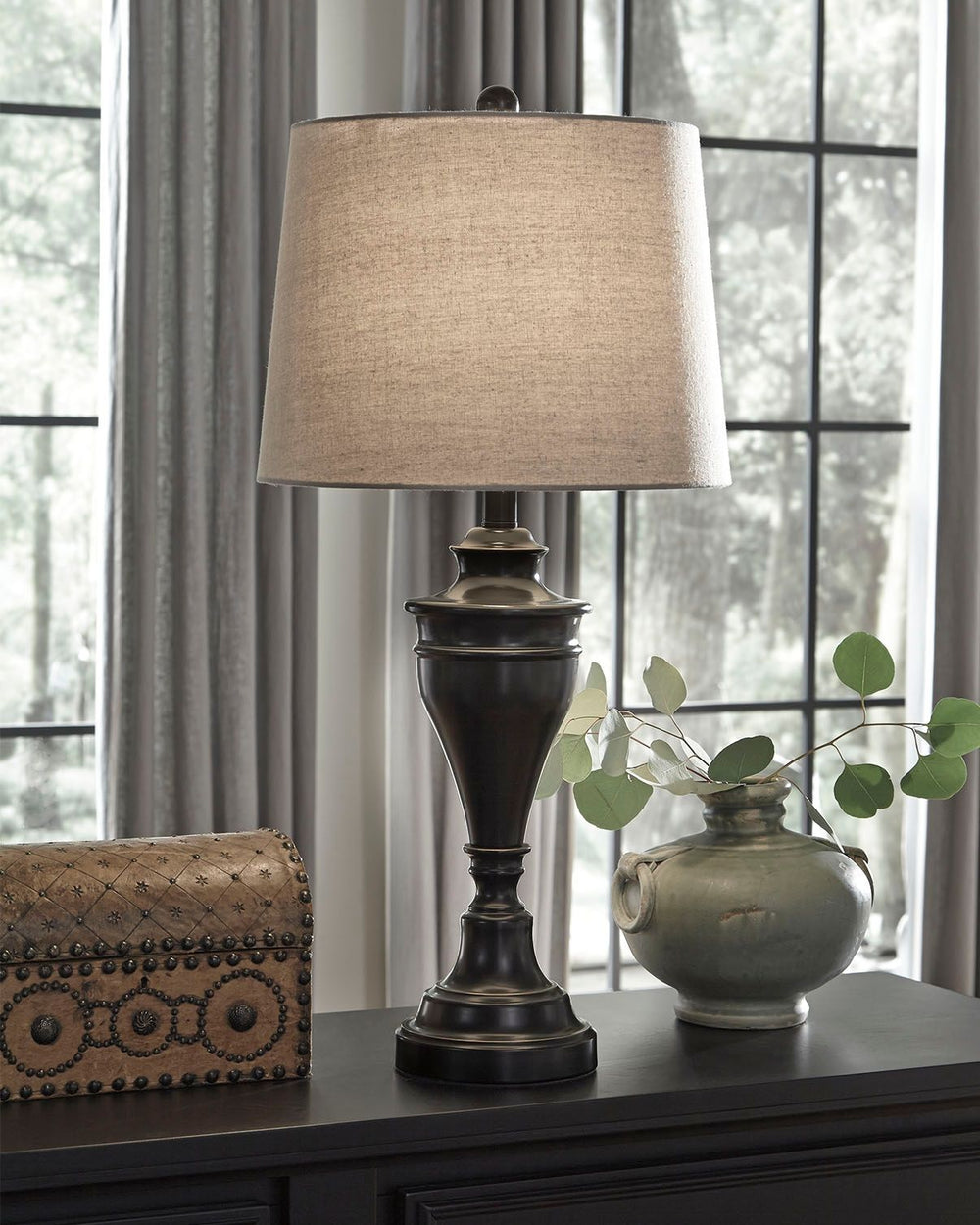 A delightfully turned pedestal base gives this table lamp a sense of easy elegance. Its dark bronze-tone metal is a simply stylish counterpoint.<br><br><b>Additional Dimensions</b><br><ul><li>Shade: 0-"</li></ul><br/><br/><b>Product Features</b><ul><li>Ma