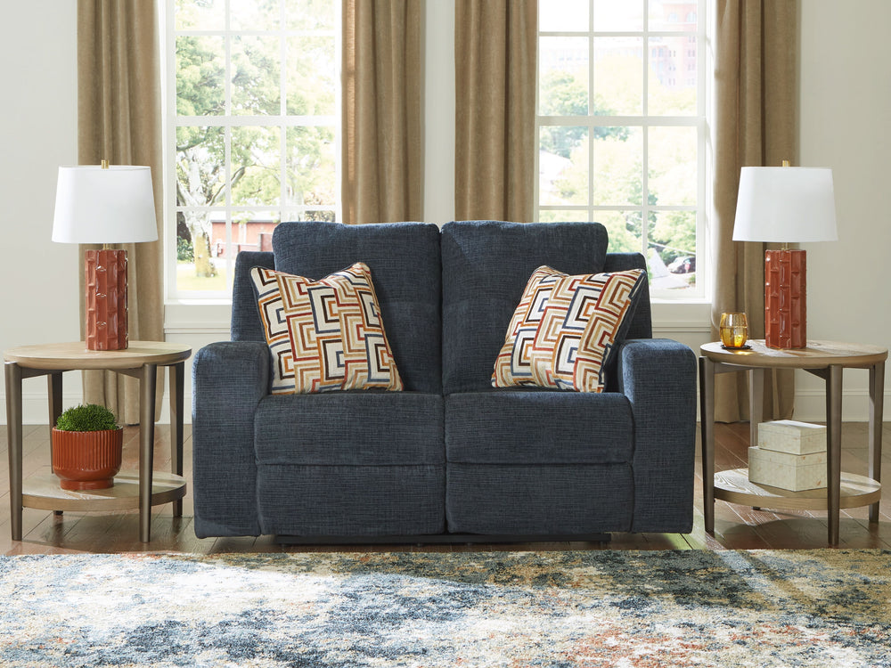 This reclining loveseat invites you to a luxuriously soft lounging experience. The chic hue fits right in with contemporary color palettes. A tufted back keeps the look right on trend. Balancing style and function, its pull tab reclining effortlessly take